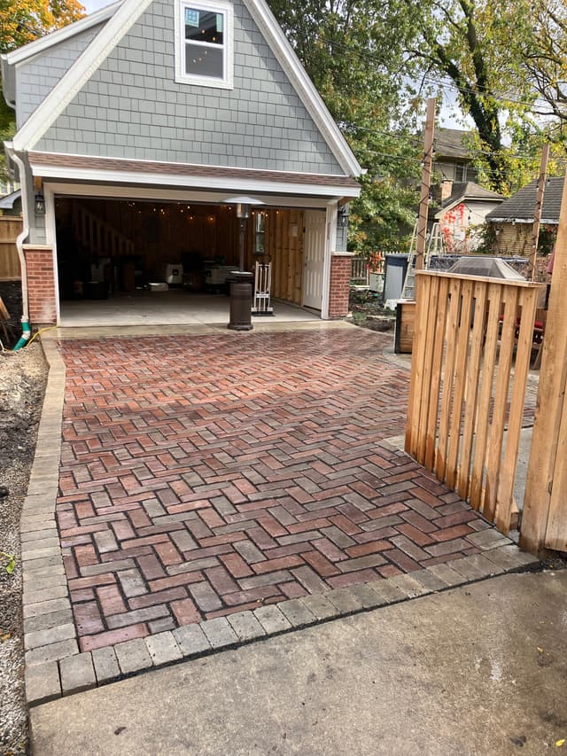 Premium red UNILOCK™ paver driveway project completed by Dufour Services